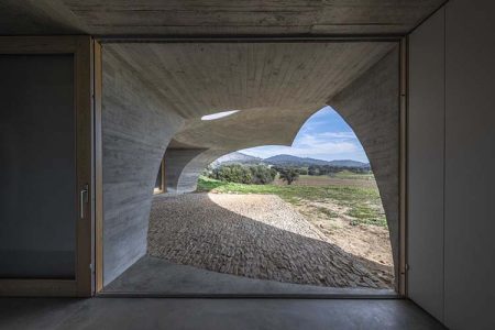 Casa con cubierta verde y integrada en el paisaje